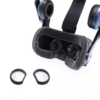 HTC Vive headset positioned with lens adapters beside, ready for installation