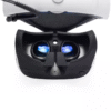 PSVR headset flipped open showing installed prescription lenses inside lens sockets