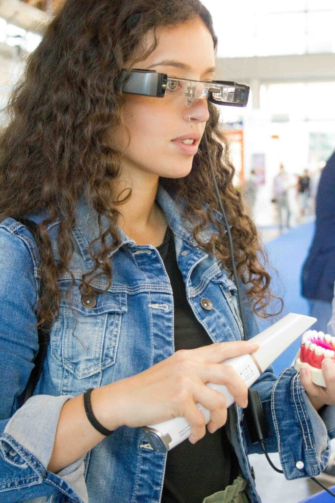 An image showing a person installing prescription lenses into a Meta Quest headset