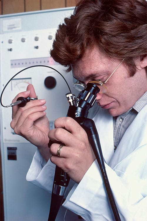 Professional adjusting Ray-Ban glasses at a repair service