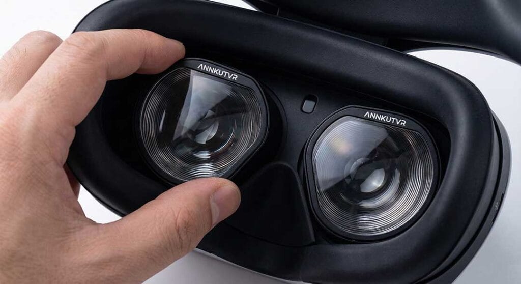 Close-up view of hand installing custom ANNKUTVR prescription lens inserts into a PS VR2 headset, showing a perfect, integrated fit.