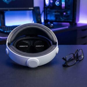 PS VR2 headset fitted with ANNKUTVR prescription lens inserts sitting next to a pair of discarded glasses.