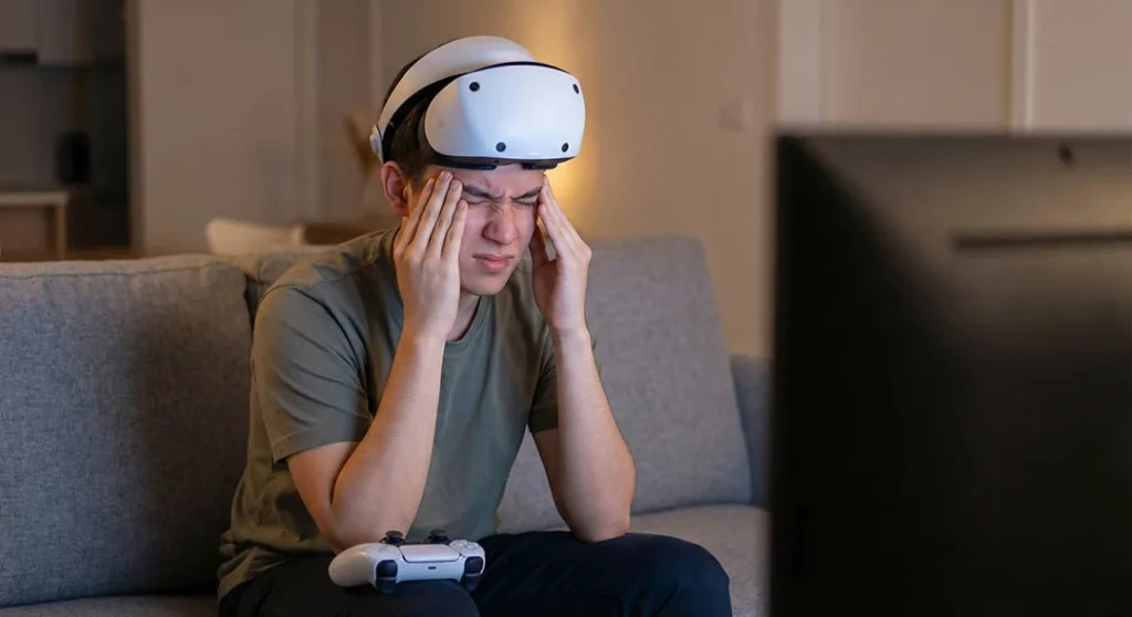 Gamer suffering from PSVR2 eye strain and headaches after playing.