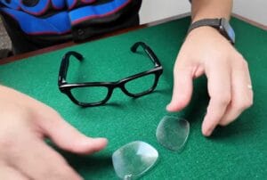 Ray-Ban Meta smart glasses with one prescription lens popped out on a cloth, showing the DIY replacement process using ANNKUTVR lenses.