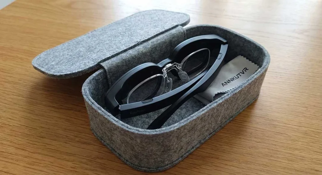 RayNeo Air 2s glasses folded neatly inside their official carrying case with ANNKUTVR prescription lenses already installed, demonstrating the "case-friendly" fit without removal.