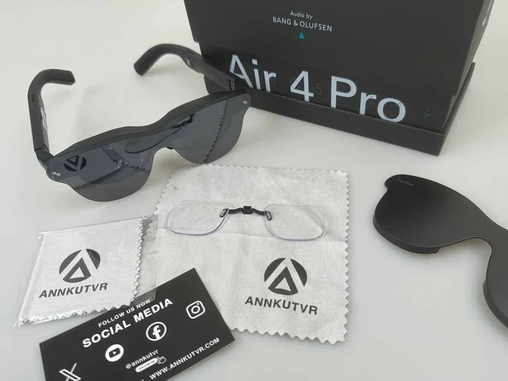 RayNeo Air 4 Pro glasses alongside custom prescription lens insert frame and microfiber cloth Caption: Ensure you have all components ready before starting the installation.